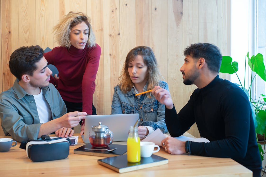 Team collaboration around a laptop